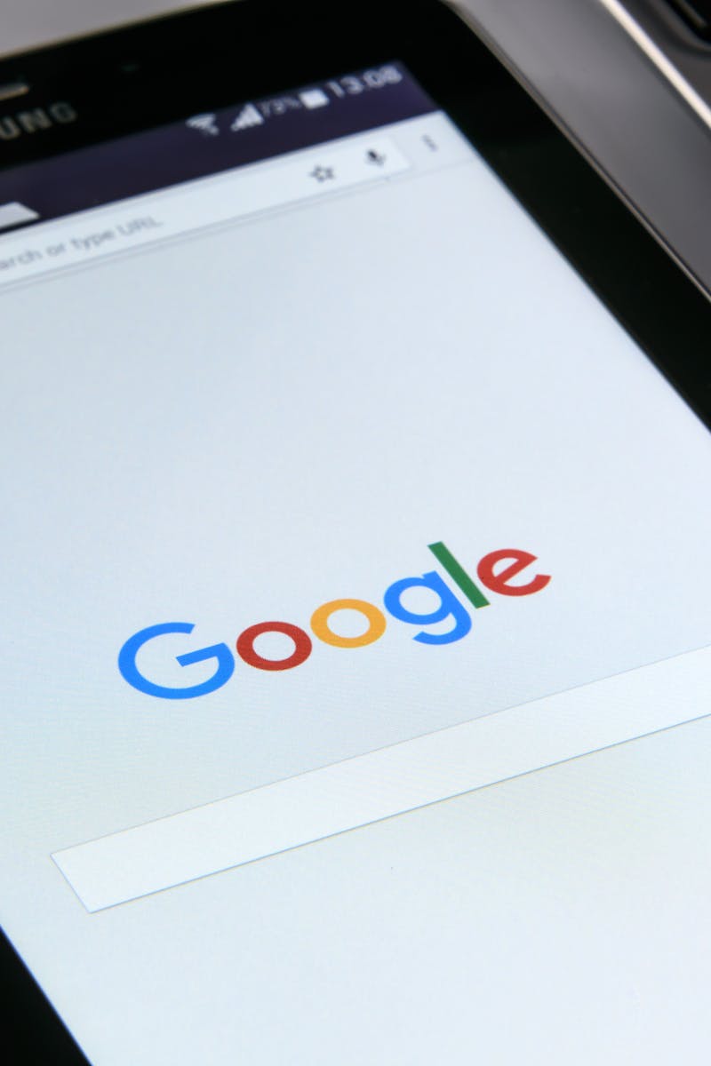 Close-up of a tablet displaying Google's search screen, emphasizing technology and internet browsing.